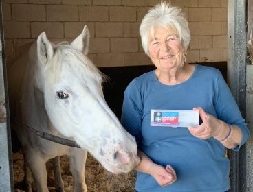 Image of older woman with white horse