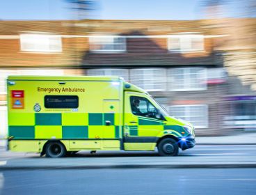 Photo of an ambulance driving through a residential area