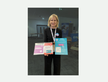Volunteer Alison holding conference packs at BES
