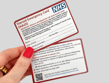 Hand holding NHS Steroid Emergency card
