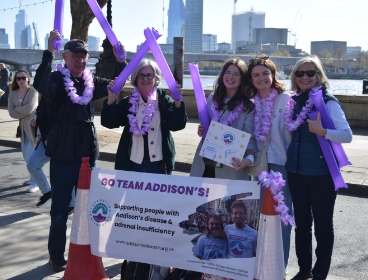 Fundraisers standing behind a banner