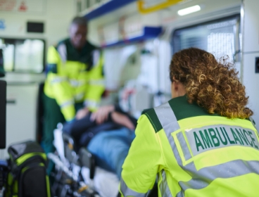 Paramedics pushing patient on stretcher